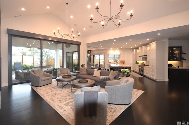 living room with a chandelier, a wealth of natural light, and dark wood-type flooring