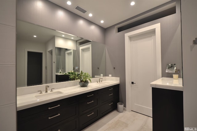 bathroom featuring double vanity, a sink, visible vents, and recessed lighting