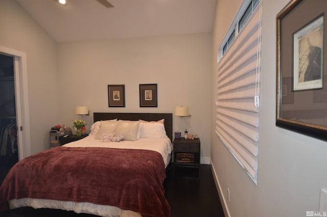 bedroom with baseboards and a walk in closet