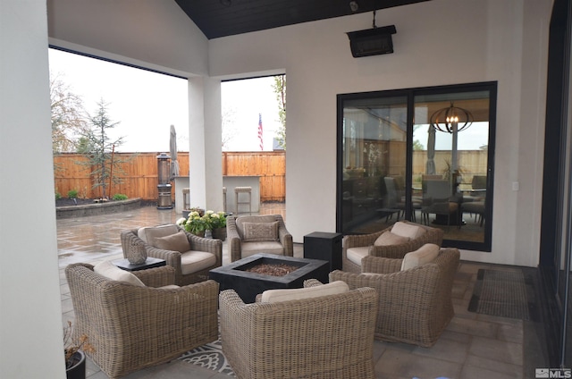 view of patio featuring an outdoor fire pit and fence