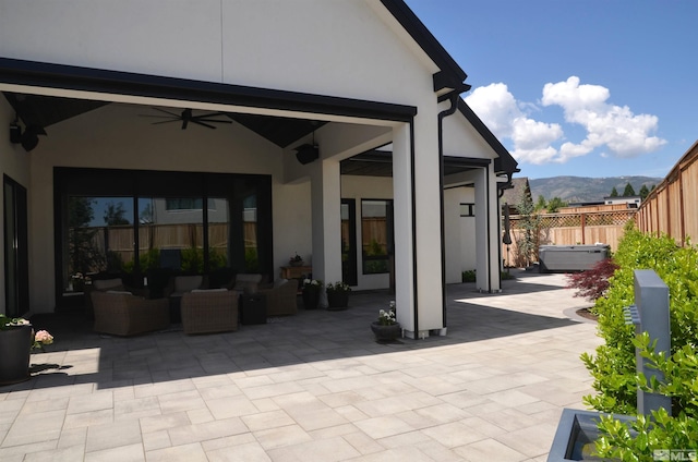 view of patio featuring ceiling fan, a fenced backyard, and a mountain view