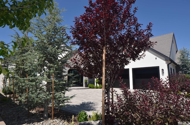 view of home's exterior featuring an attached garage and stucco siding