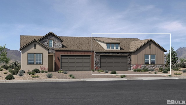 view of front of property featuring a mountain view and a garage