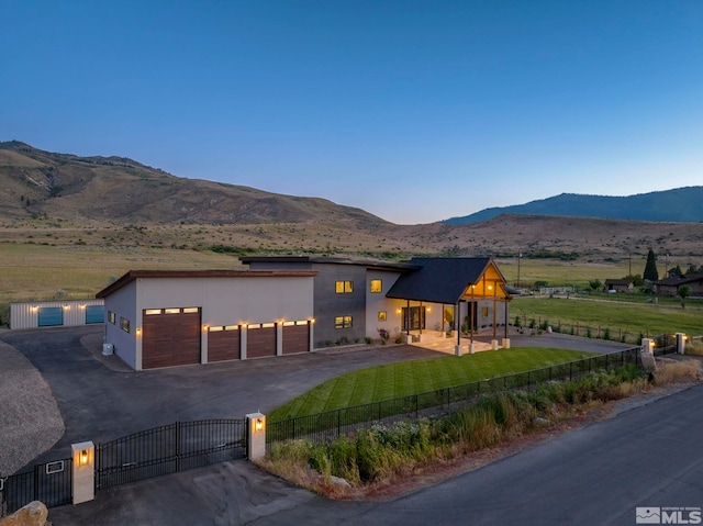 view of front facade featuring a garage and a mountain view