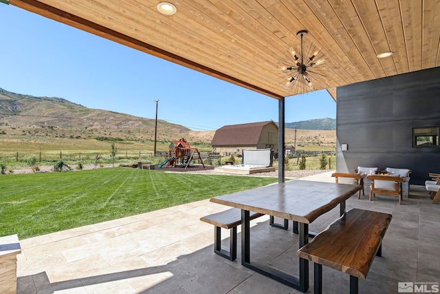 view of patio / terrace featuring a mountain view and a playground