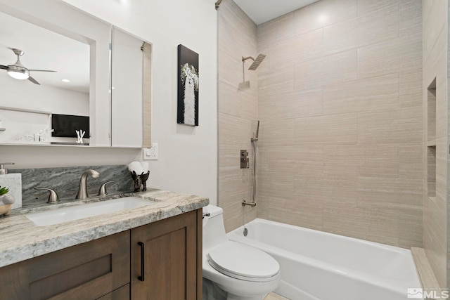 full bathroom with vanity, toilet, tiled shower / bath combo, and ceiling fan