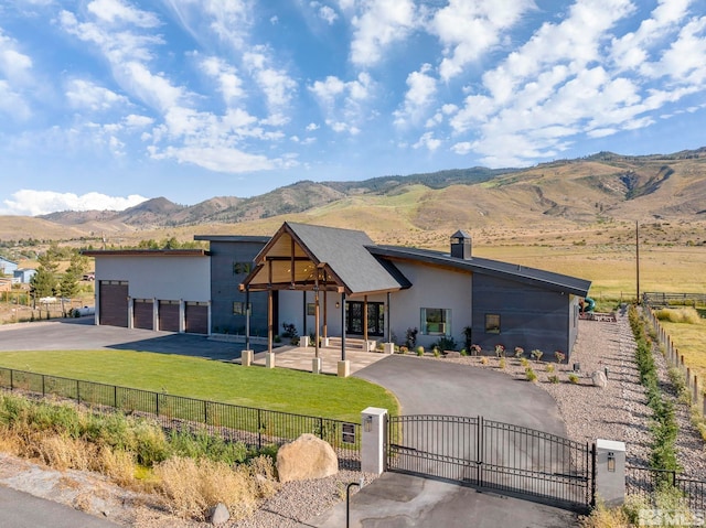 view of front facade with a mountain view and a front yard