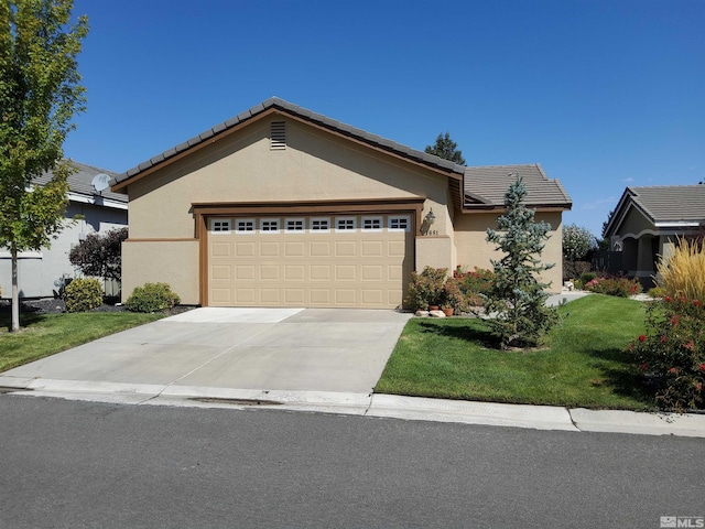 view of front of home featuring a front lawn and a garage