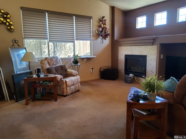 living room with carpet floors and a fireplace