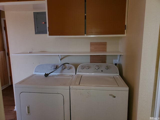 laundry area featuring electric panel, cabinets, hardwood / wood-style floors, and washer and dryer