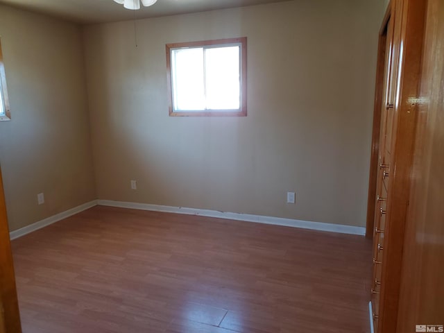 empty room with wood-type flooring and ceiling fan