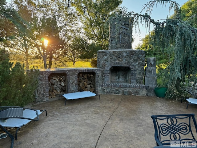 view of patio featuring an outdoor stone fireplace