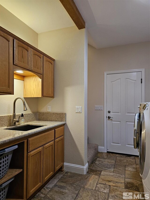 kitchen featuring washer and clothes dryer and sink