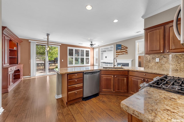 kitchen with crown molding, sink, ceiling fan, appliances with stainless steel finishes, and hardwood / wood-style flooring