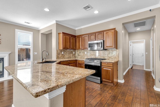 kitchen with backsplash, stainless steel appliances, dark hardwood / wood-style flooring, kitchen peninsula, and sink