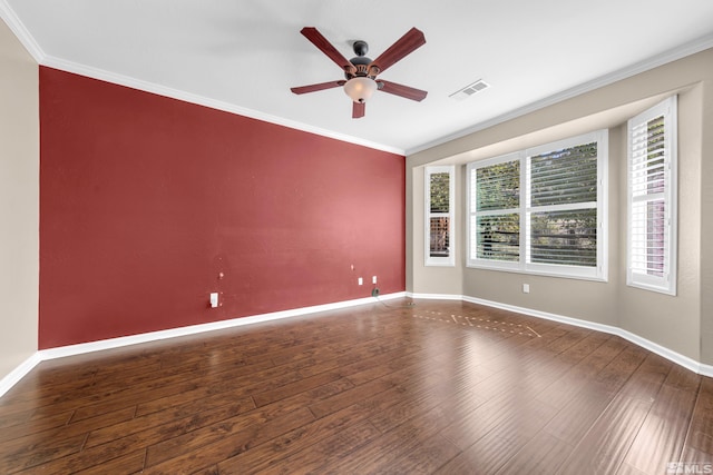 spare room with dark wood-type flooring, ceiling fan, and ornamental molding