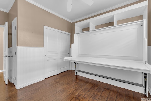 interior space featuring ceiling fan, ornamental molding, and dark hardwood / wood-style flooring