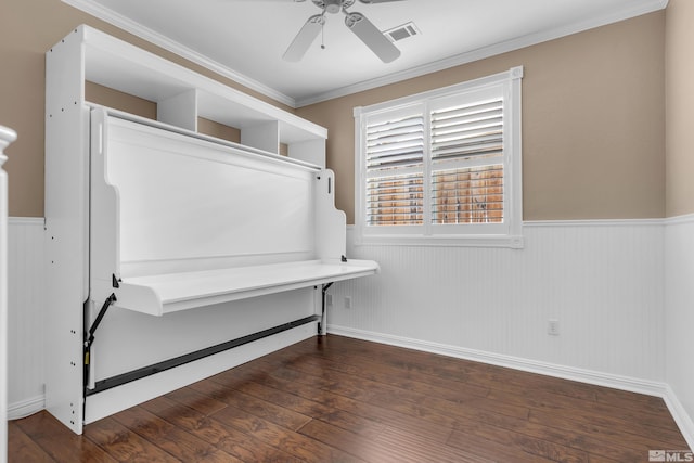 interior space with crown molding, dark wood-type flooring, and ceiling fan