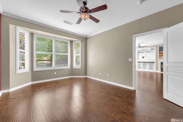 spare room featuring ornamental molding, ceiling fan, and dark hardwood / wood-style floors