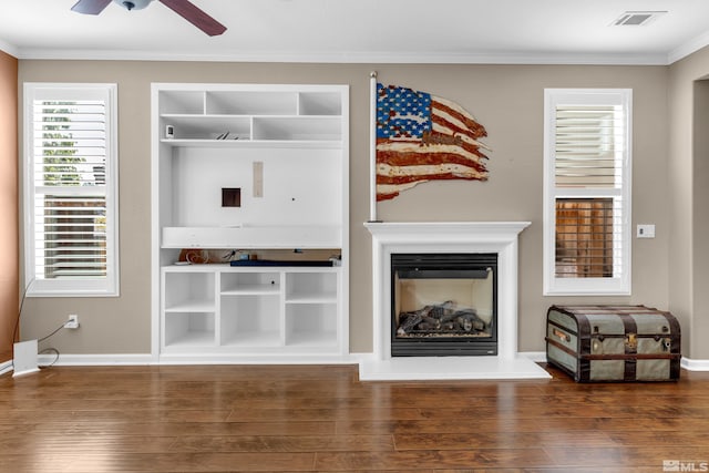 living room featuring ceiling fan, ornamental molding, and wood-type flooring