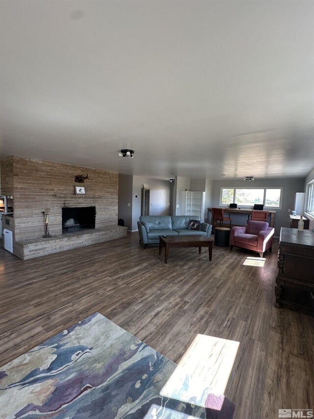 corridor with a barn door, dark hardwood / wood-style flooring, and a textured ceiling