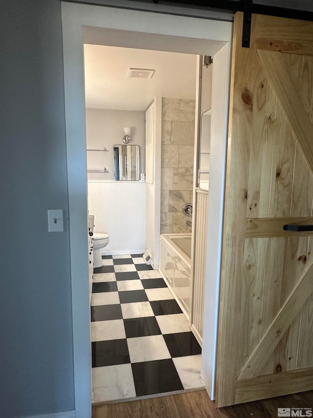 bathroom with a tub and toilet