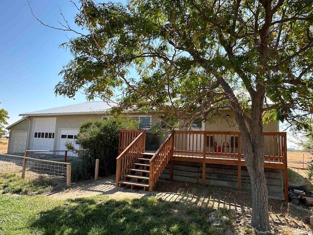 rear view of property featuring a wooden deck