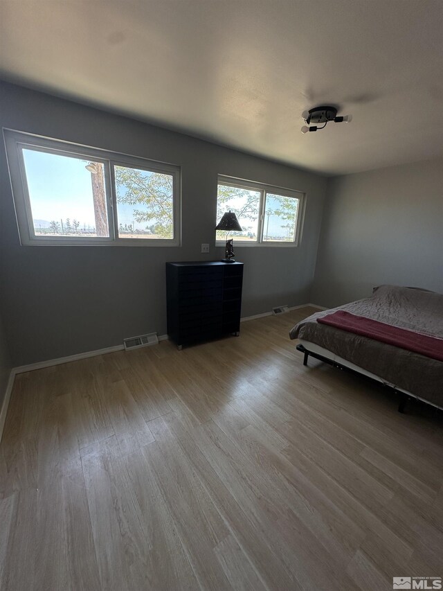 unfurnished bedroom featuring hardwood / wood-style flooring