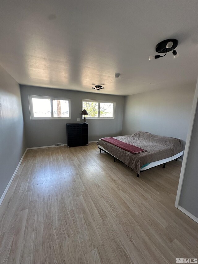 unfurnished bedroom featuring billiards, ceiling fan, a closet, and wood-type flooring