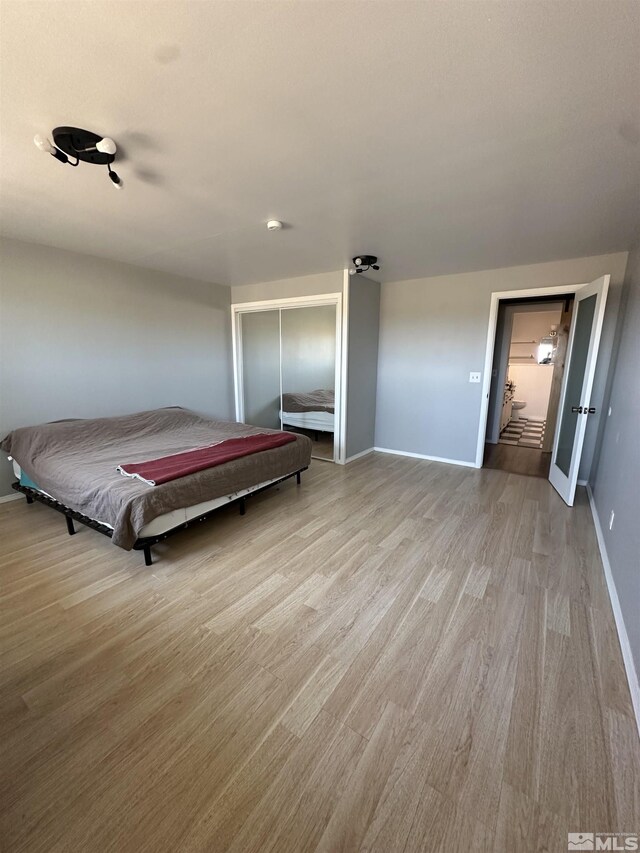 unfurnished bedroom with two closets, dark hardwood / wood-style flooring, and a textured ceiling