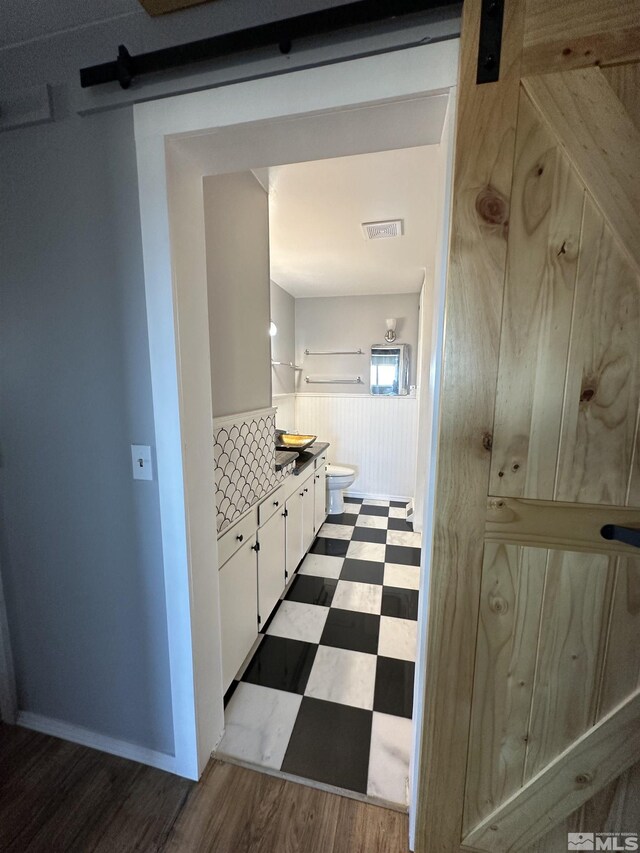 interior details featuring wood-type flooring and a brick fireplace