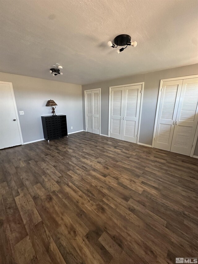 living room with dark wood-type flooring and a fireplace