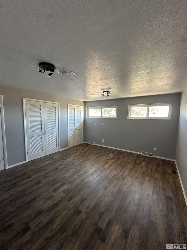 living room with dark hardwood / wood-style floors and a healthy amount of sunlight