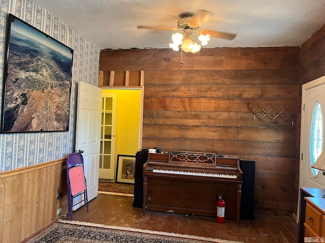 bedroom featuring a textured ceiling, wooden walls, and dark hardwood / wood-style flooring