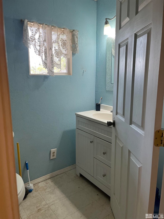 bathroom featuring vanity, toilet, and tile patterned floors