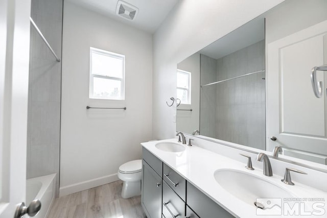 full bathroom with baseboards, visible vents, a sink, and toilet