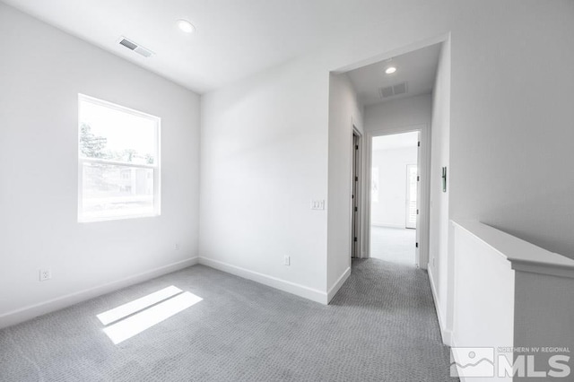 empty room featuring baseboards, carpet, visible vents, and recessed lighting