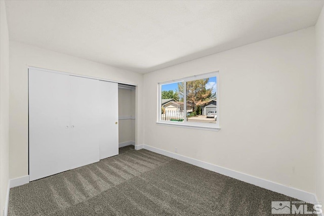 unfurnished bedroom with carpet and a closet