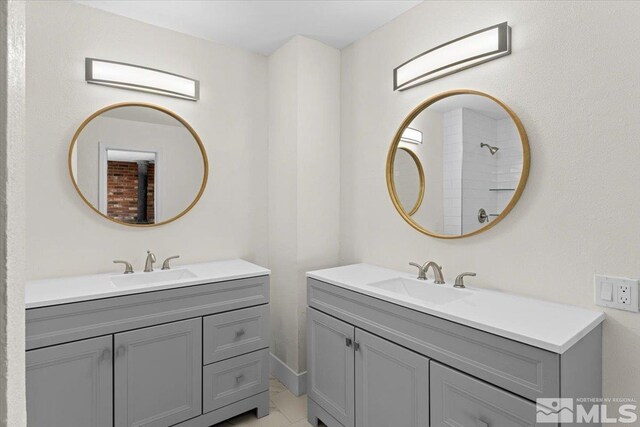 bathroom featuring vanity, a shower, and tile patterned flooring