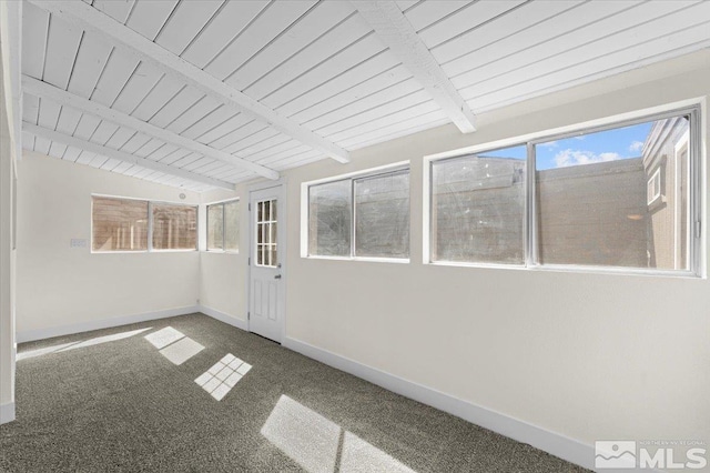 interior space featuring carpet, wooden ceiling, and beam ceiling