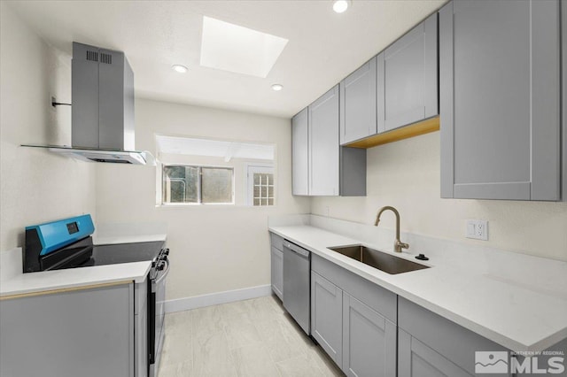 kitchen featuring gray cabinetry, sink, appliances with stainless steel finishes, and island exhaust hood