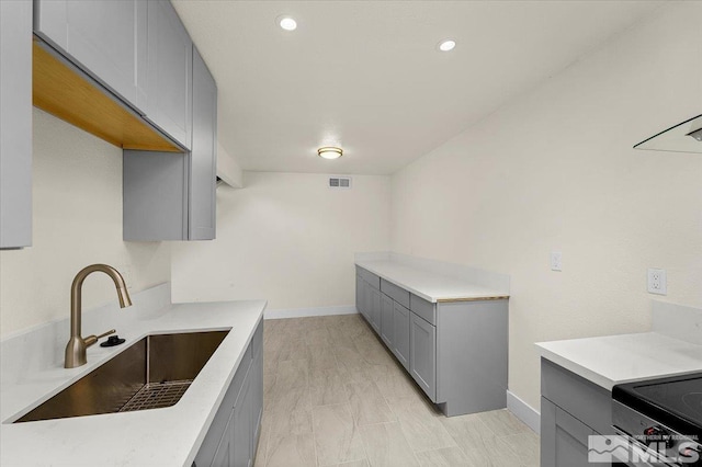 kitchen featuring gray cabinetry and sink