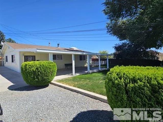 back of house featuring a patio area, stucco siding, a yard, and fence