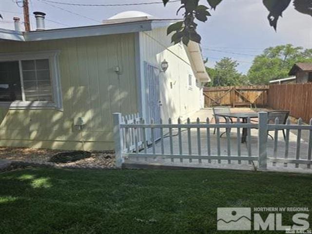 view of home's exterior featuring a gate, a patio area, and fence