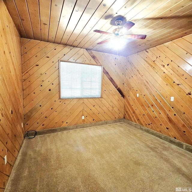 bonus room with ceiling fan, wooden walls, wood ceiling, and carpet floors