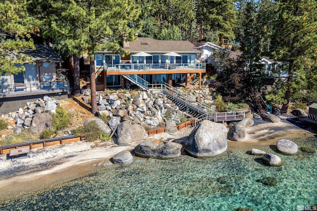 back of property with stairway and a wooden deck