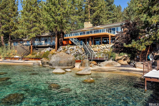 rear view of property featuring a deck