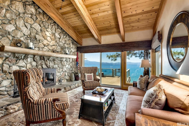 living room with lofted ceiling with beams, a stone fireplace, and wooden ceiling