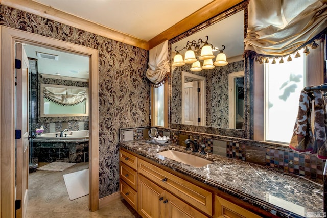 bathroom with wallpapered walls, visible vents, a garden tub, and vanity