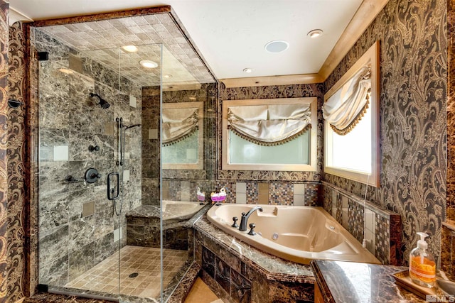 bathroom featuring a stall shower and a whirlpool tub